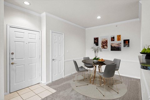 a dining room with a table and four chairs